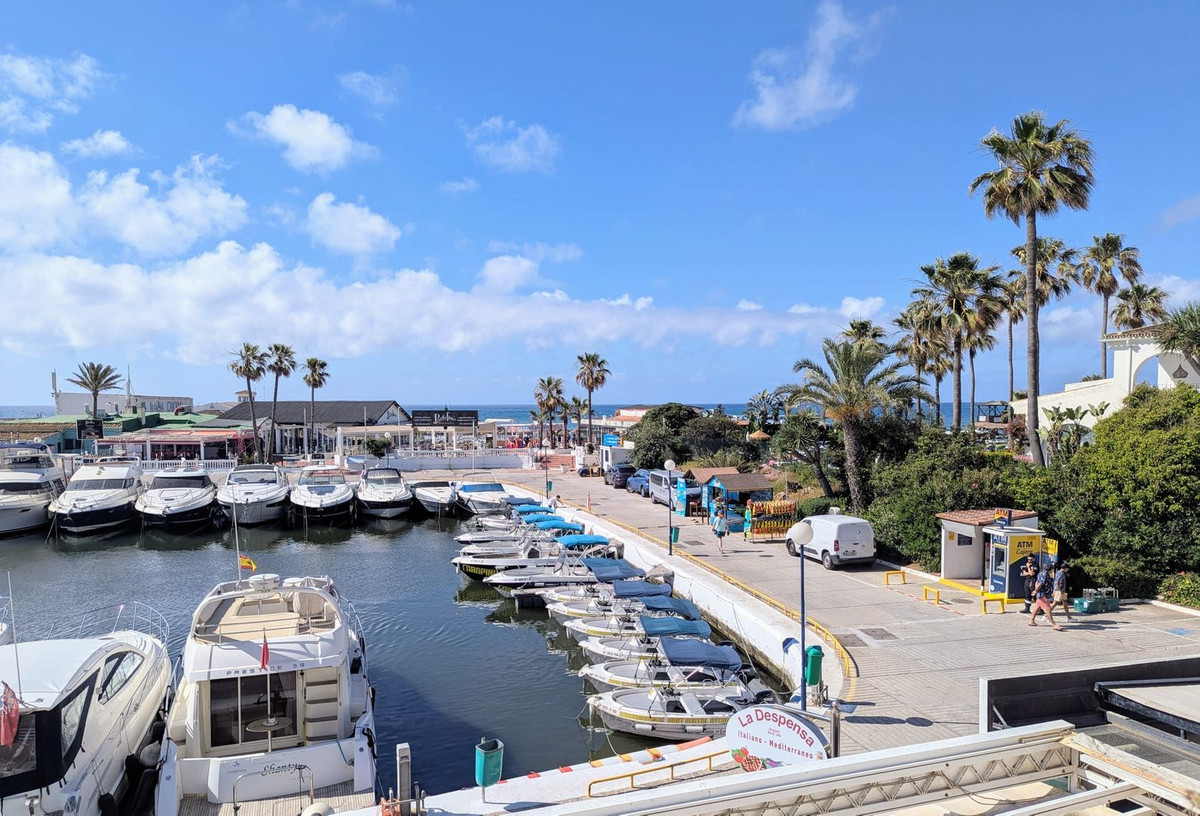 Homes and sailing boats around Cabopino marina